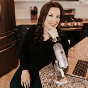 woman sitting at kitchen island with podcast mic